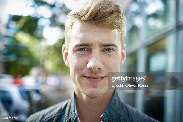 portrait of smiling young man outdoors - 若い男性一人 ストックフォトと画像