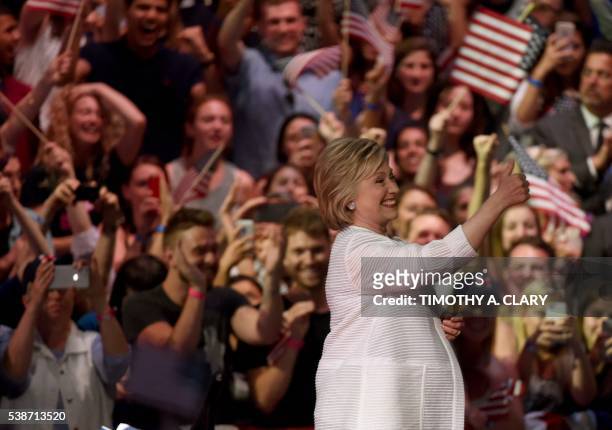 Democratic presidential candidate Hillary Clinton acknowledges celebratory cheers from the crowd during her primary night event at the Duggal...