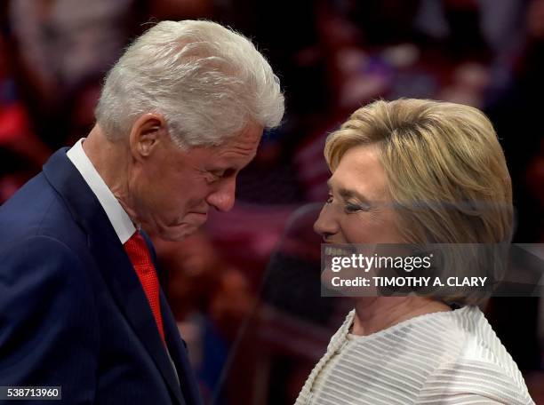 Democratic presidential candidate Hillary Clinton shares a moment on stage with husband, former US president Bill Clinton during her primary night...