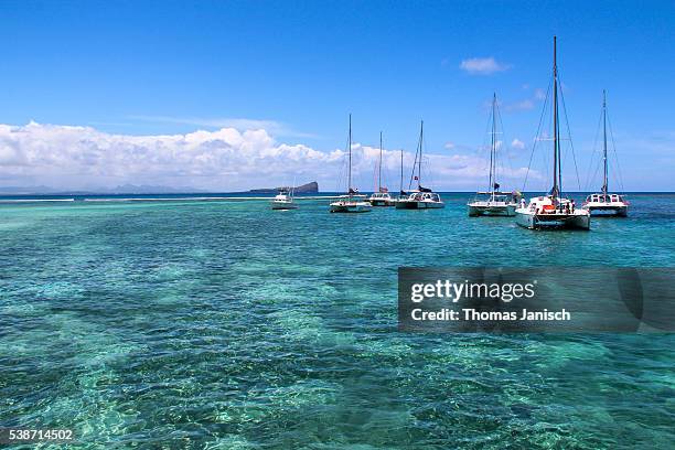 catamarans in the blue and crystal clear water of gabriel island, mauritius - catamaran stock pictures, royalty-free photos & images
