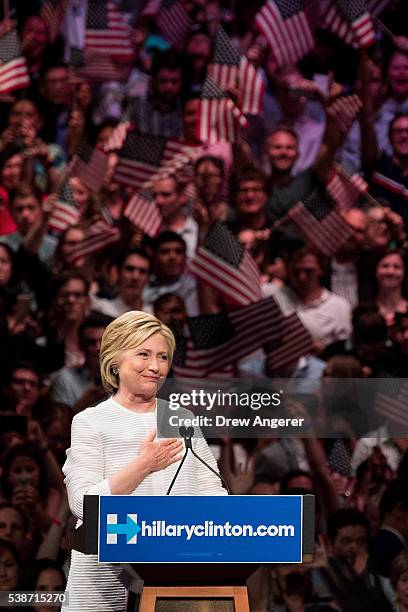 Democratic presidential candidate Hillary Clinton gestures to the crowd at the start of her remarks during a primary night rally at the Duggal...