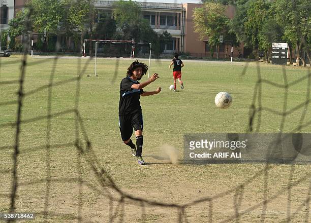 In this photograph taken on May 4 Pakistani national cricket and football player Diana Baig takes part in a football training session at a ground in...
