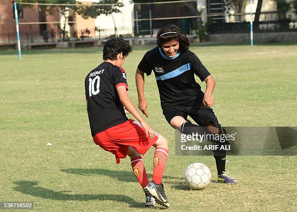 In this photograph taken on May 4 Pakistani national cricket and football player Diana Baigtakes part in a football training session at a ground in...