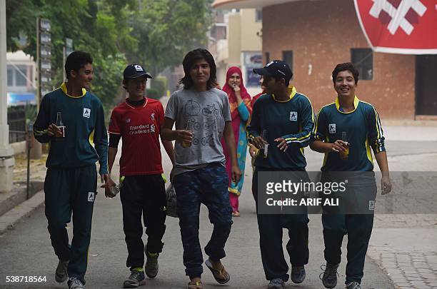 In this photograph taken on May 3 Pakistani national cricket and football player Diana Baig shares a light moment with her colleagues at a football...