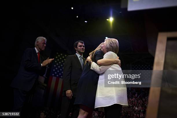 Hillary Clinton, former Secretary of State and presumptive Democratic presidential nominee, right, embraces her daughter Chelsea Clinton, second...