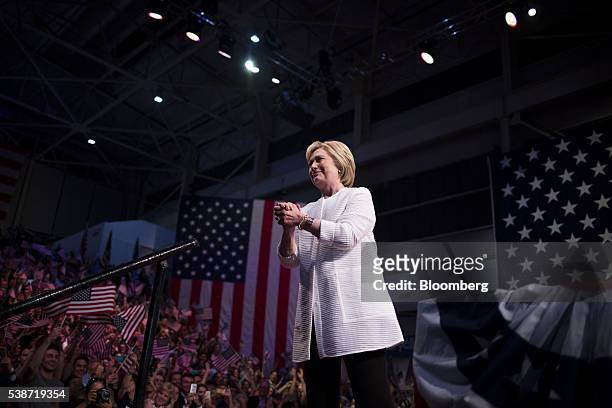 Hillary Clinton, former Secretary of State and presumptive Democratic presidential nominee, gestures to attendees during a primary night event at the...
