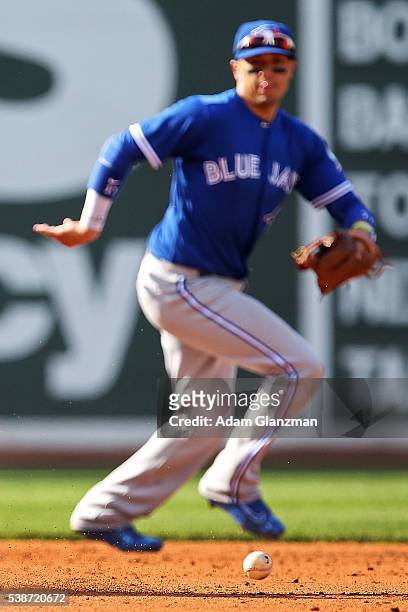 Matt Dominguez of the Toronto Blue Jays chases down a loose ball in the fourth inning during the game against the Boston Red Sox at Fenway Park on...