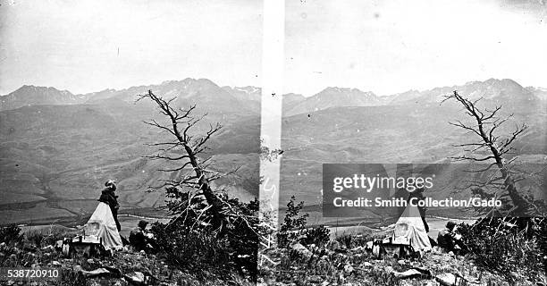 Stereograph of two USGS employees at a field camp, overlooking the Blue River, Summit County, Colorado, 1874. Image courtesy USGS. .