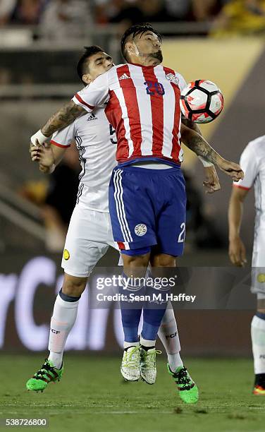 Guillermo Celis of Colombia and Victor Ayala of Paraguay battle for a loose ball during the second half of a 2016 Copa America Centenario Group A...