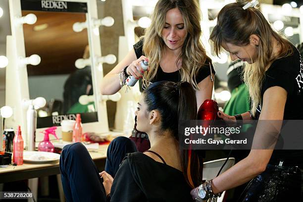 Model prepares in makeup and hair backstage ahead of the FW Trends Runway as part of the Mercedes Benz Fashion Festival Sydney 2012 at Sydney Town...