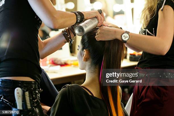 Model prepares in makeup and hair backstage ahead of the FW Trends Runway as part of the Mercedes Benz Fashion Festival Sydney 2012 at Sydney Town...