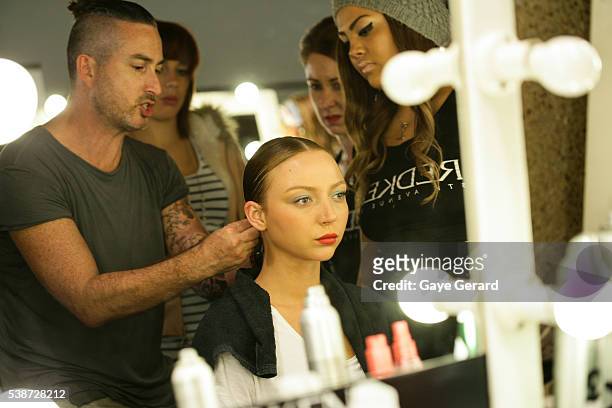 Model prepares in makeup and hair backstage ahead of the FW Trends Runway as part of the Mercedes Benz Fashion Festival Sydney 2012 at Sydney Town...