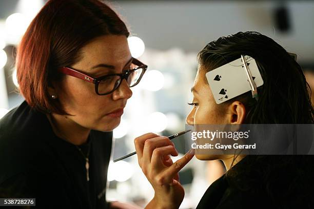 Model prepares in makeup and hair backstage ahead of the FW Trends Runway as part of the Mercedes Benz Fashion Festival Sydney 2012 at Sydney Town...