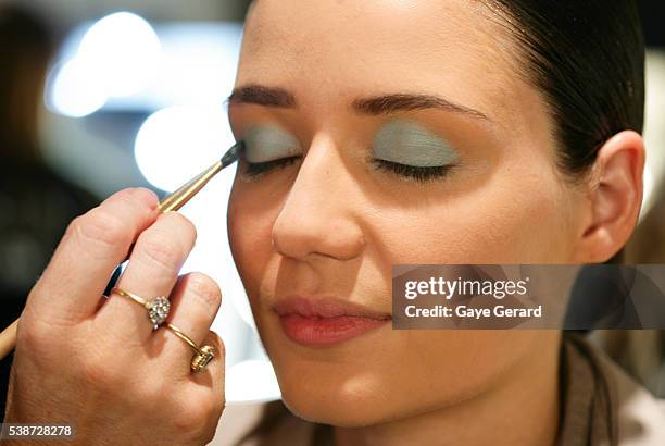 Model prepares in makeup and hair backstage ahead of the FW Trends Runway as part of the Mercedes Benz Fashion Festival Sydney 2012 at Sydney Town...