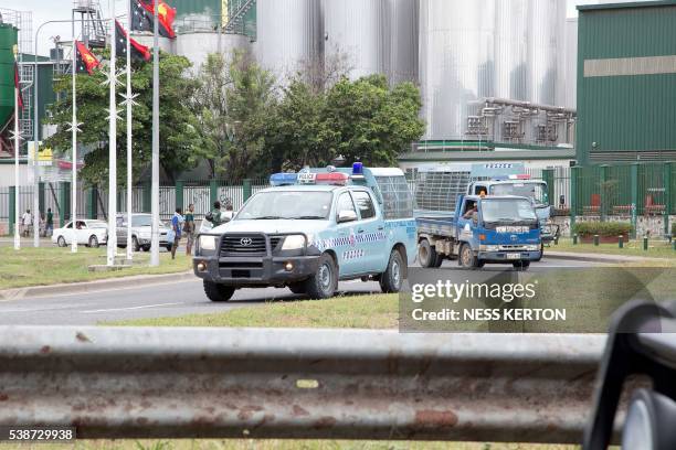 Police on patrol ask people to get off the roads following a protest rally by the students in Port Moresby on June 8, 2016. - Police in Papua New...