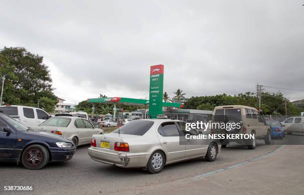 Motorists queue up to get fuel in panic in light of the escalating violence following a protest rally by the students in Port Moresby on June 8,...