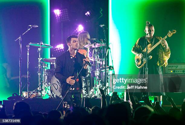 Singer Joe Jonas, drummer Jack Lawless and bassist Cole Whittle of DNCE perform at Time Warner Cable Arena on June 7, 2016 in Charlotte, North...