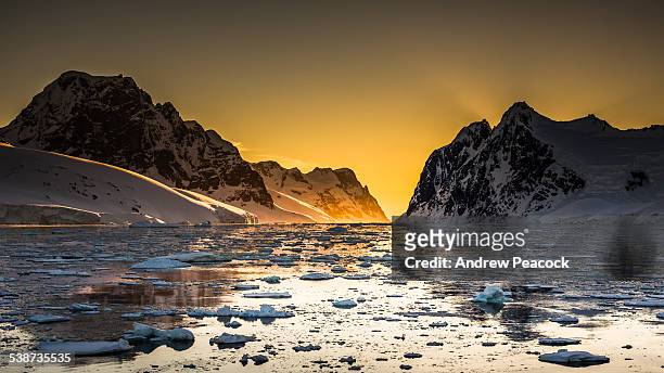 the narrow lemaire channel at sunset - antarctica sunset stock pictures, royalty-free photos & images