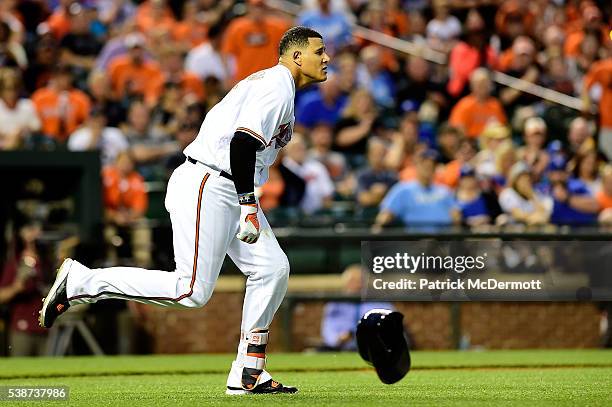 Manny Machado of the Baltimore Orioles charges the mound after being hit by a pitch thrown by Yordano Ventura of the Kansas City Royals in the fifth...