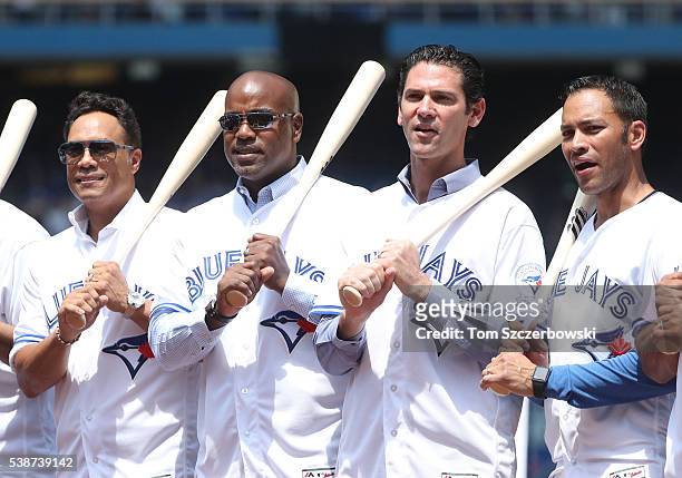 Former players Roberto Alomar of the Toronto Blue Jays poses beside Carlos Delgado and Shawn Green and Jose Cruz during 40th anniversary celebrations...