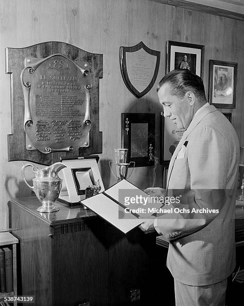 Ed Sullivan host of "Toast of the Town" poses in his office at the Maxine Elliott Theater in New York, New York.