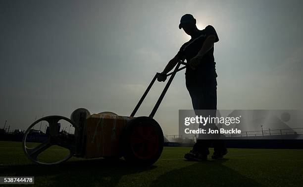 Member of the ground staff prepare the court ahead of play on day three of the WTA Aegon Open on June 8, 2016 in Nottingham, England.