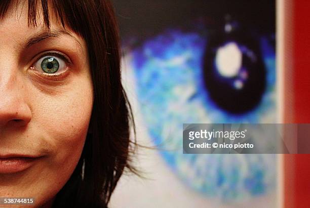 half woman face and big eye in the background - human eye stockfoto's en -beelden