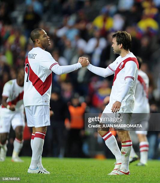 Peruvian defender Alberto Rodriguez celebrates with teammate Renzo Revoredo at the end of the third-place match of the 2011 Copa America football...