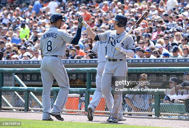 Desmond Jennings and Brandon Guyer of the Tampa Bay Rays high-five during the game against the Detroit Tigers at Comerica Park on May 22, 2016 in...
