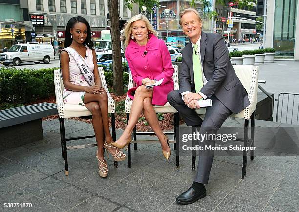 Miss USA Deshauna Barber poses for a photo with Fox & Friends hosts Ainsley Earhardt and Steve Doocy when she visits Fox & Friends on June 8, 2016 in...