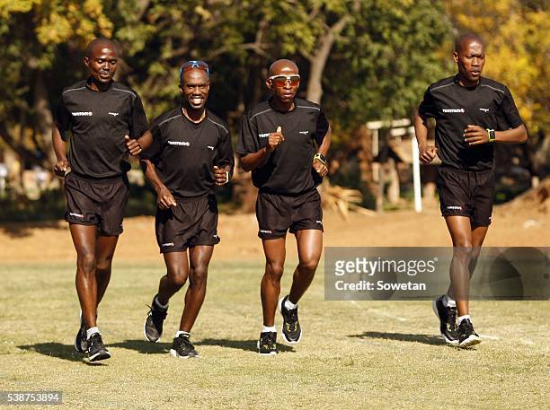 Comrades Marathon winner; David Gatebe and his teammates; Peter Gaebetse, Gift Kelehe and Gordon Lesetedi jog at their training ground on June 01,...