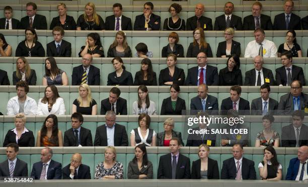 Guests listen as US President Barack Obama addresses the Australian Parliament in Canberra, Australia, on November 17, 2011. AFP PHOTO / Pool / Saul...