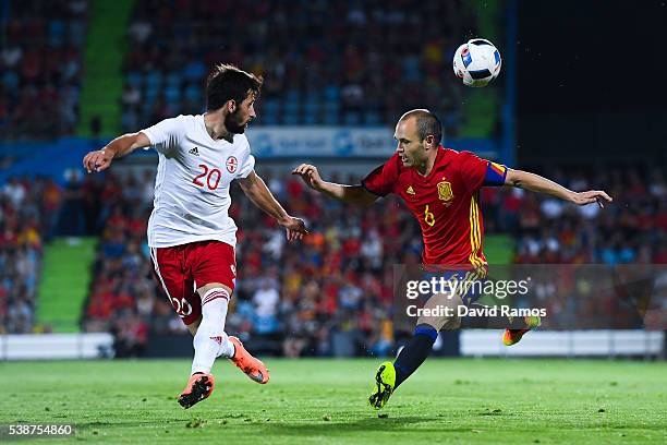 Andres Iniesta of Spain competes for the ball with Jigauri of Georgia during an international friendly match between Spain and Georgia at Alfonso...