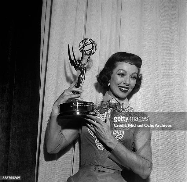 Actress Loretta Young poses with her Emmy Award for "The Loretta Young Show -1953 - 1961" during the 7th Primetime Emmy Awards in Los Angeles,CA.