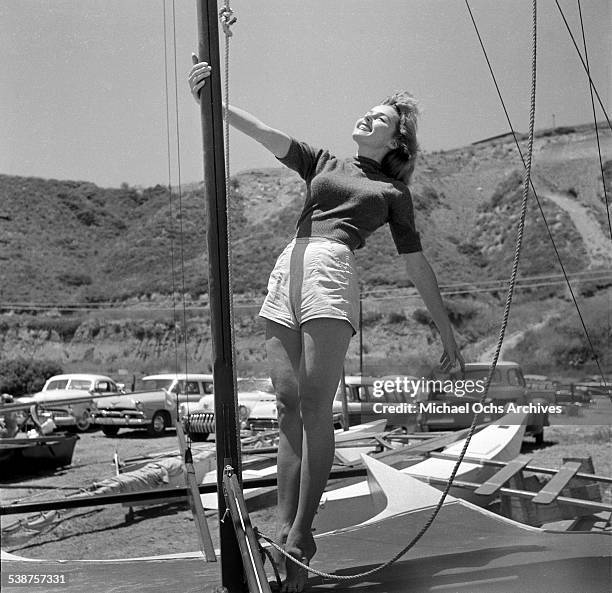 Actress Elaine Stewart poses on a sailboat during the Thalians Beach Ball in Malibu,California. .