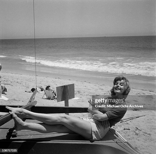 Actress Elaine Stewart poses on the beach during the Thalians Beach Ball in Malibu,California. .
