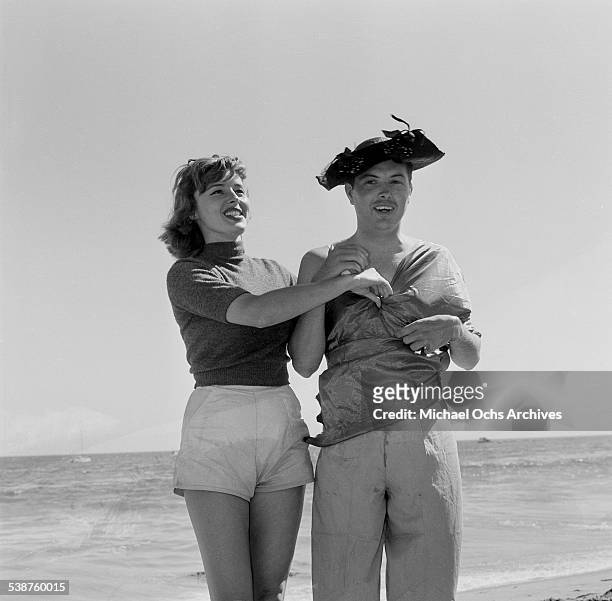 Actress Elaine Stewart dresses man during the Thalians Beach Ball in Malibu,California.