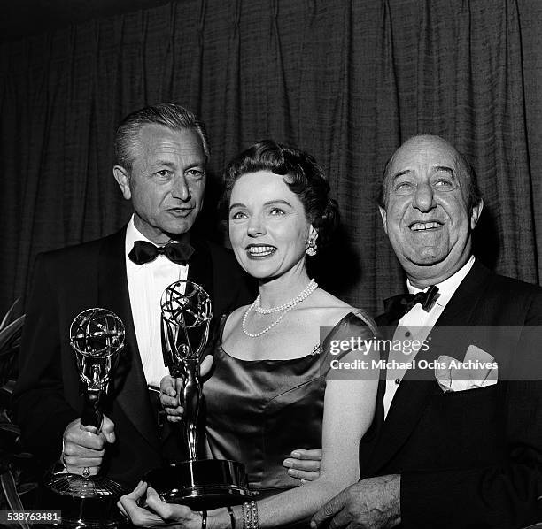 Comedian and actor Ed Wynn poses with actor Robert Young and actress Jane Wyatt after they won Emmy Awards during the 10th Primetime Emmy Awards in...