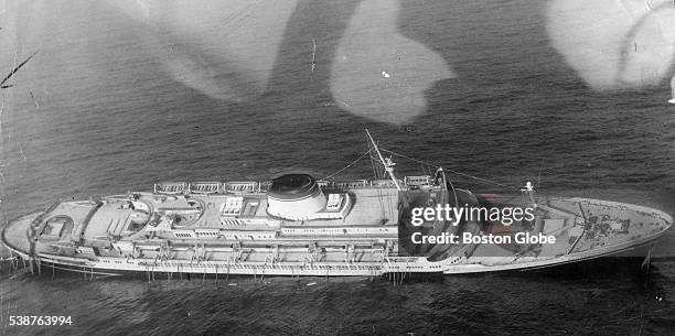 The Italian liner Andrea Doria leans to right as the ship steadily sinks 45 miles off the coast of Nantucket, Mass., seen in an aerial, on July 25,...