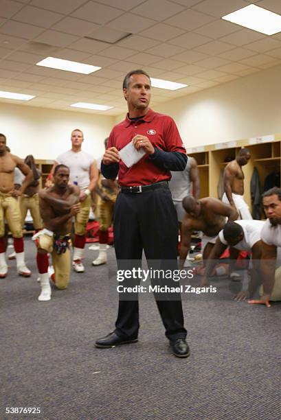 Head Coach Mike Nolan of the San Francisco 49ers addresses the team in the locker room after the game against the Denver Broncos at Invesco Field at...