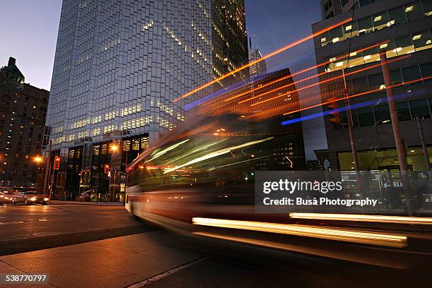 vehicle light trails, twilight in downtown toronto - bus road stock pictures, royalty-free photos & images