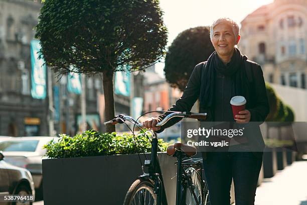 businesswoman commuting to work. - coffee bike stock pictures, royalty-free photos & images