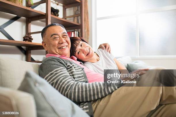 senior couple relaxing together - happy anniversary stock pictures, royalty-free photos & images