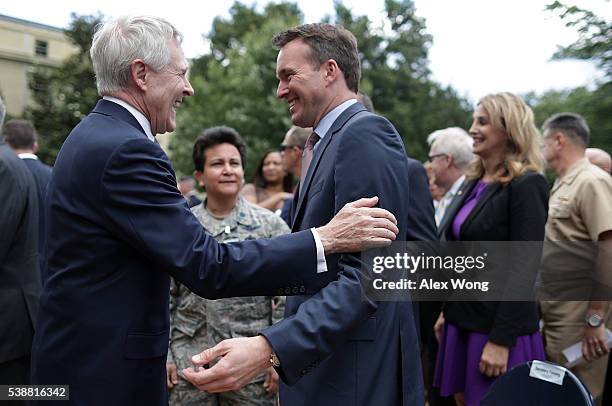 Navy Secretary Ray Mabus talks to Army Secretary Eric Fanning during a Lesbian, Gay, Bisexual and Transgender Pride Month Ceremony at the Pentagon...