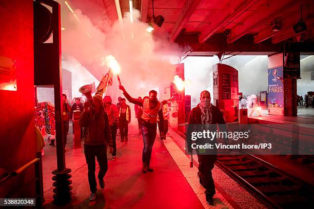 Rail workers, who demonstrate against the new Labour Law, known as the 'El-Khomri Law’, cross the docks of the Montparnasse train station on June 6,...