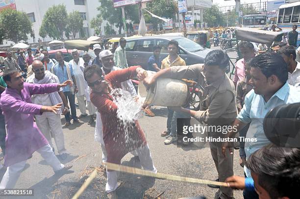 Police trying extinguish an effigy of Prime Minister Narendra Modi burned by Congress workers during protest against Central Government over the...