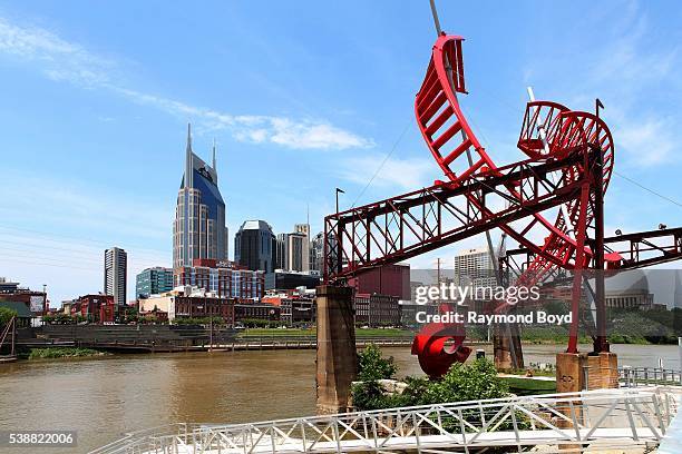 Nashville skyline and Alice Aycock's 'Ghost Ballet for the East Bank Machineworks' sculpture as photographed from the Nashville Riverfront Landing in...