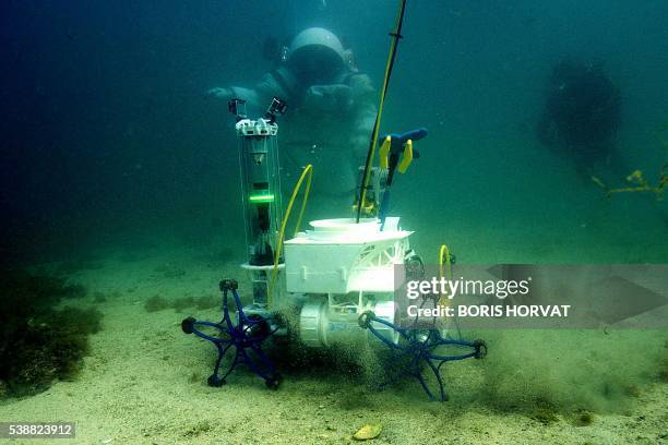Comex diver wearing a Gandolfi space suit practises underwater during a "Moonwalk" operation in the Mediterranean sea at the Frioul islands near...
