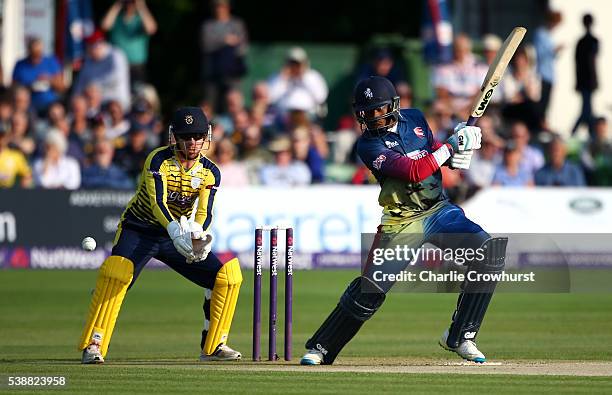 Daniel Bell-Drummond of Kent hits out while wicket keeper Adam Wheater of Hampshire looks on during the NatWest T20 Blast match between Kent and...