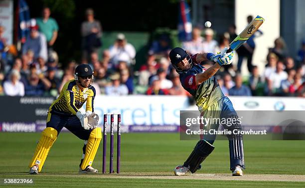 Joe Denly of Kent hits out while wicket keeper Adam Wheater of Hampshire looks on during the NatWest T20 Blast match between Kent and Hampshire at...